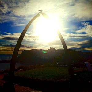 arch with a building in the background in Whitby, Photo Torched Views